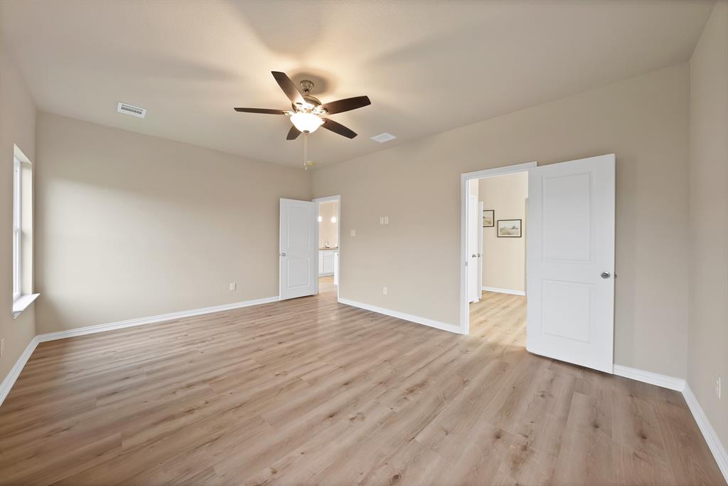 106 Panther Loop Mabank, TX 75147 - Photo 20 of 34 an empty room with wooden floor fan and windows