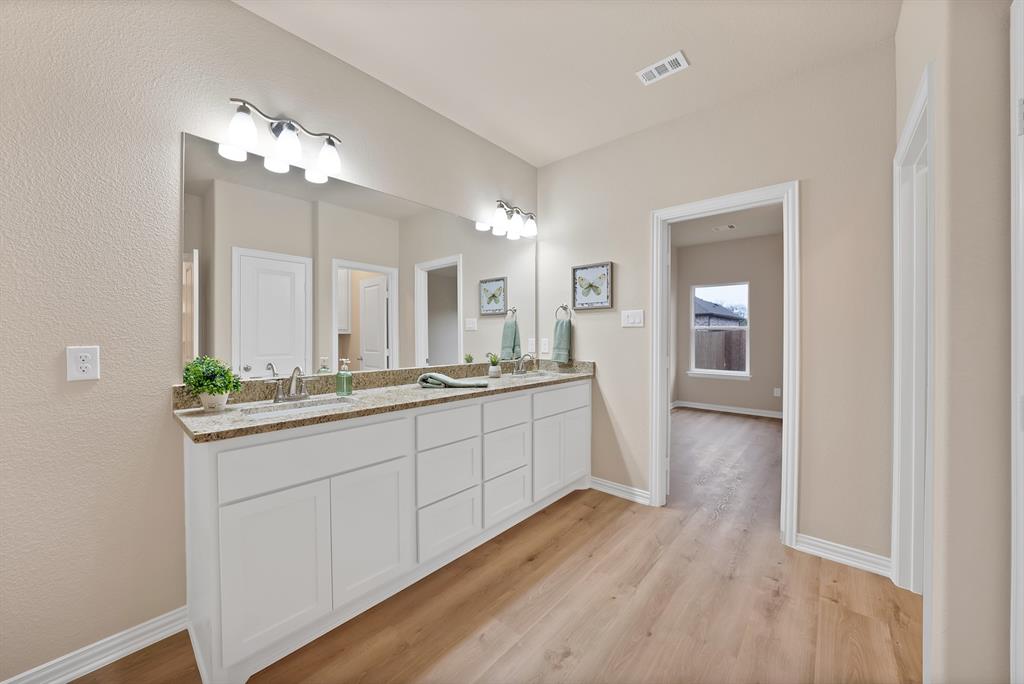 106 Panther Loop Mabank, TX 75147 - Photo 22 of 34 a large bathroom with a double vanity sink and a mirror