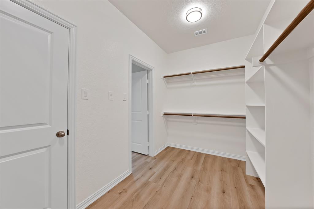 106 Panther Loop Mabank, TX 75147 - Photo 23 of 34 a view of walk in closet with empty racks