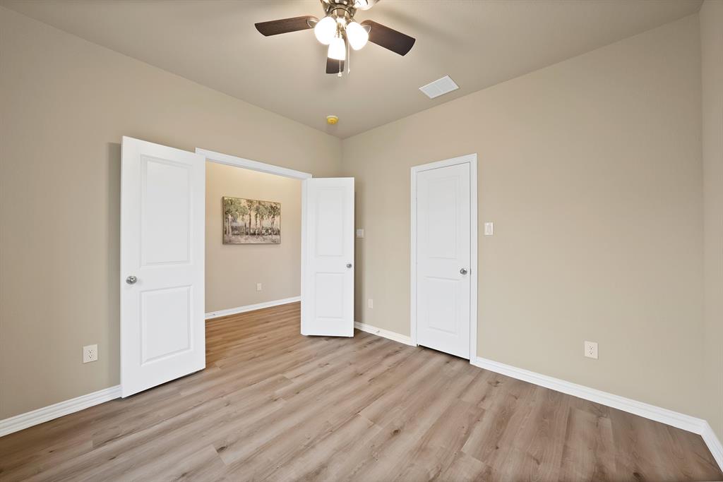 106 Panther Loop Mabank, TX 75147 - Photo 25 of 34 an empty room with wooden floor and ceiling fan