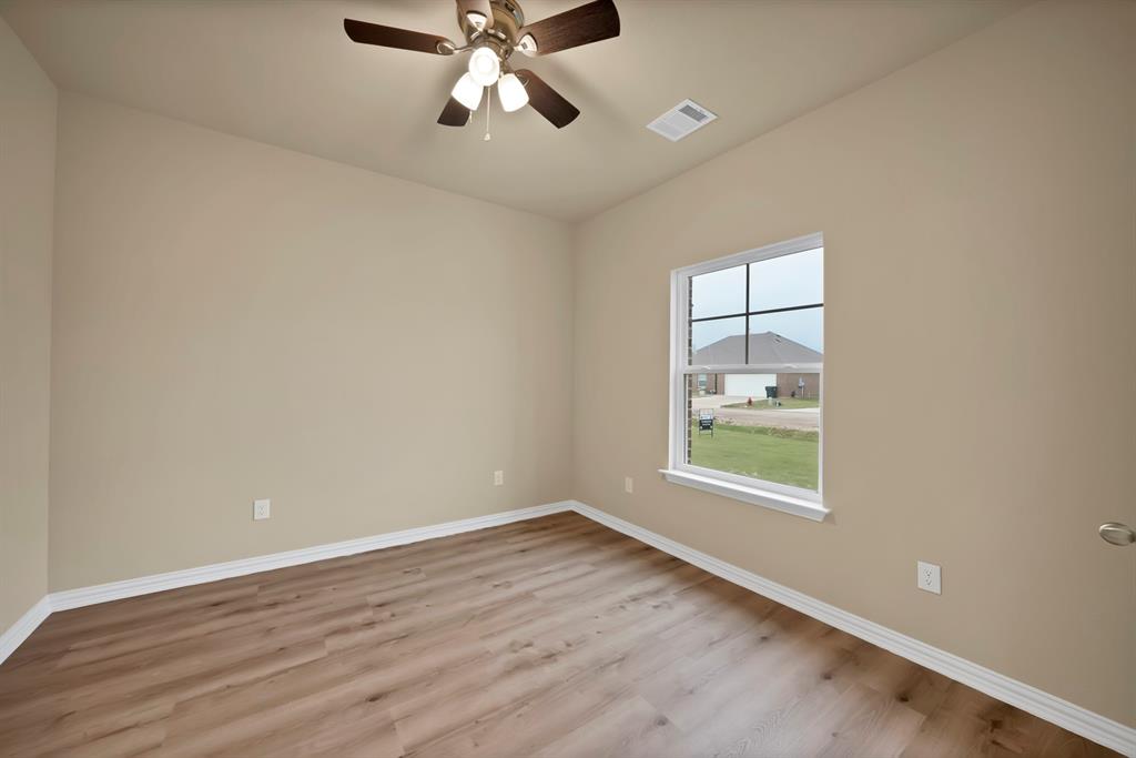 106 Panther Loop Mabank, TX 75147 - Photo 27 of 34 an empty room with wooden floor fan and windows