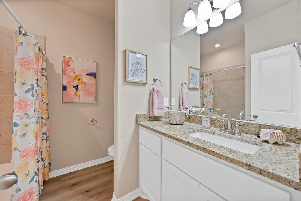 106 Panther Loop Mabank, TX 75147 - Photo 28 of 34 a bathroom with a granite countertop sink a mirror and shower