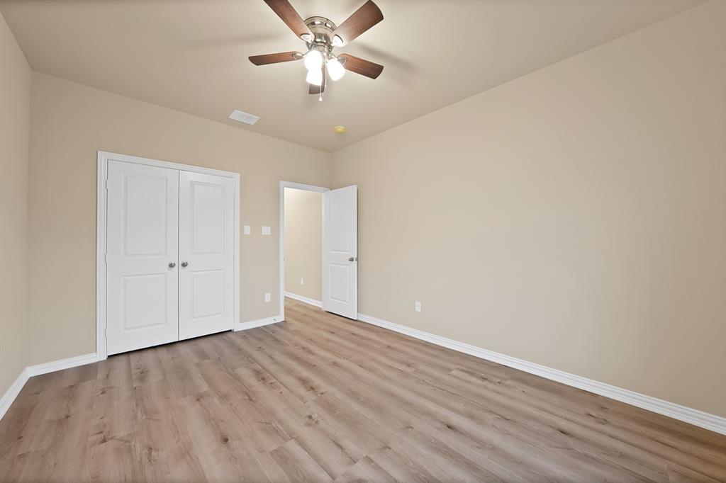 106 Panther Loop Mabank, TX 75147 - Photo 32 of 34 an empty room with wooden floor and windows