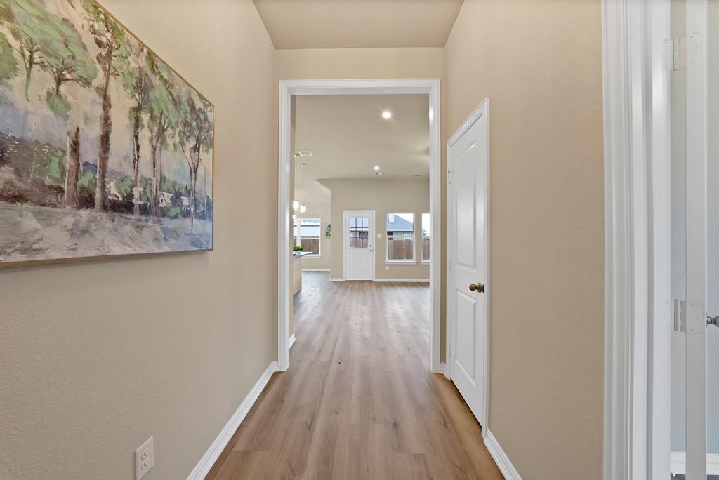106 Panther Loop Mabank, TX 75147 - Photo 7 of 34 a view of a hallway with wooden floor and staircase