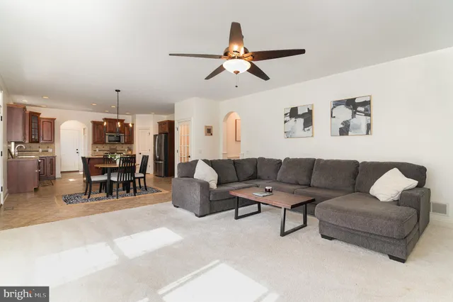 a living room with furniture and kitchen view