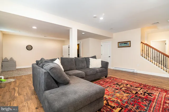 a living room with furniture and a rug
