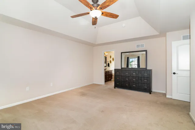 a living room with furniture and a ceiling fan