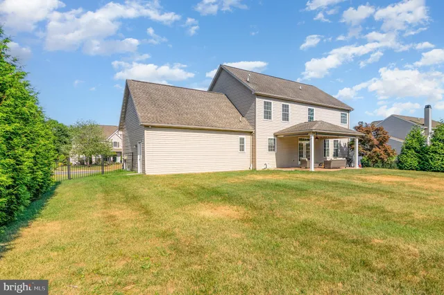 a view of yard with swimming pool and green space