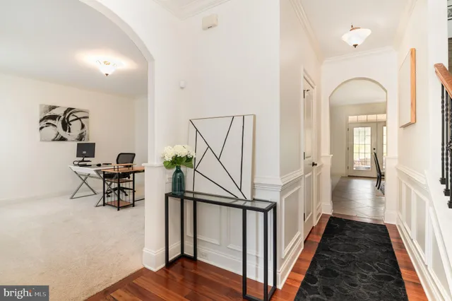 a view of entryway and hall with wooden floor