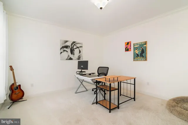 a workspace with furniture and ceiling fan