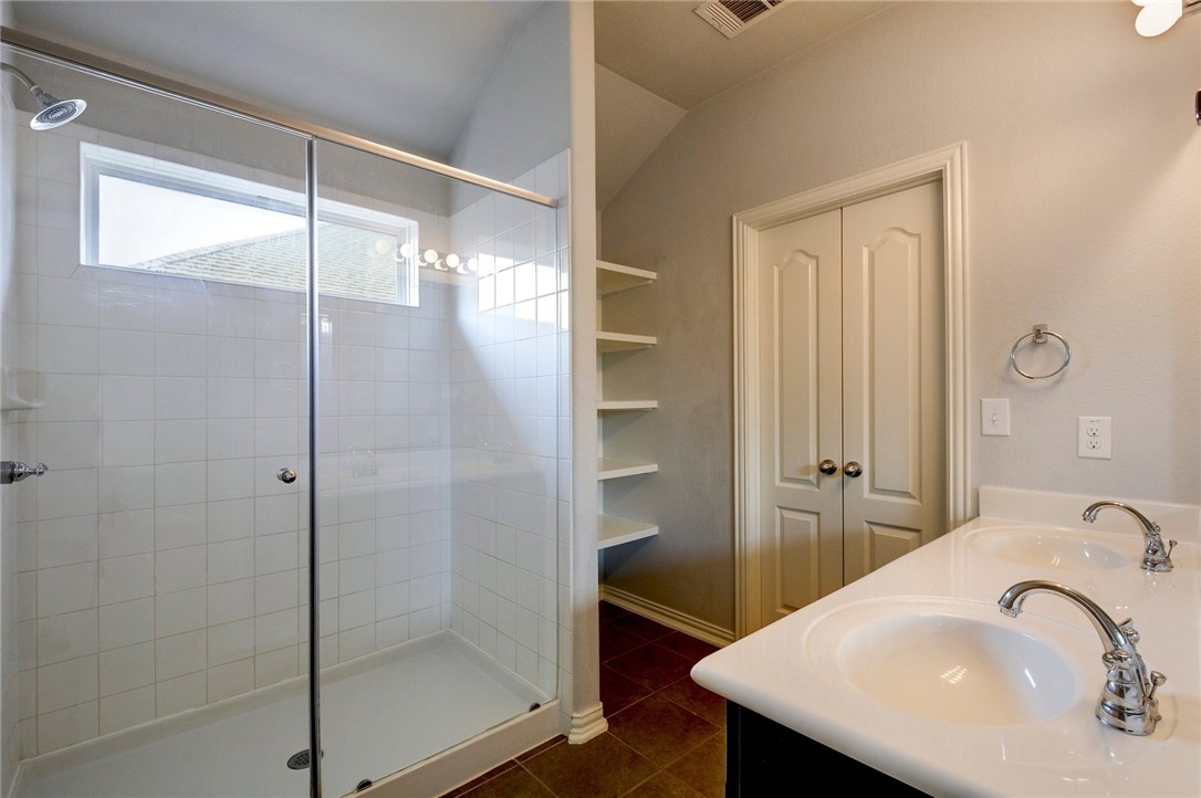 3621 Rams Horn Way Round Rock, TX 78665 - Photo 16 of 24 a bathroom with a shower sink and mirror