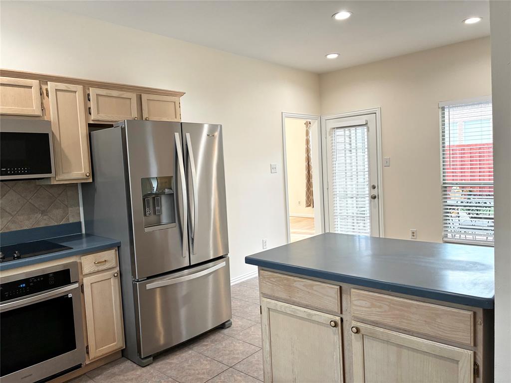 7936 Tournament Road Frisco, TX 75035 - Photo 10 of 28 a kitchen with stainless steel appliances a refrigerator sink and microwave