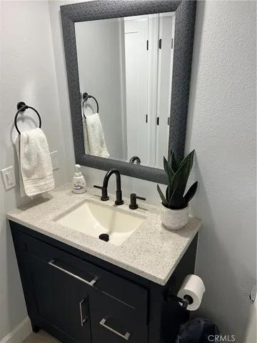 a large bed sitting in a bedroom next to a cabinet