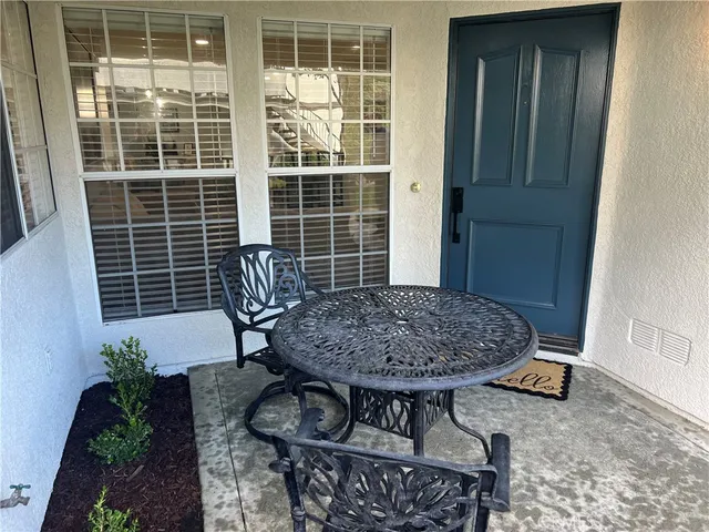 a view of a house with swimming pool and sitting area