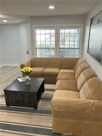 a living room with furniture and a large window