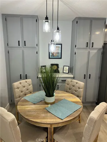 a dining room with furniture and wooden floor