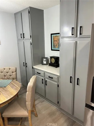 a kitchen with stainless steel appliances a sink a stove a microwave a refrigerator a stove and cabinets