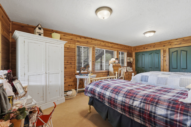 6 Beaver Springs Rancheros Oakley, UT 84055 - Photo 40 of 68 Room featuring wood-paneled walls, white textured ceiling, and two windows with blinds