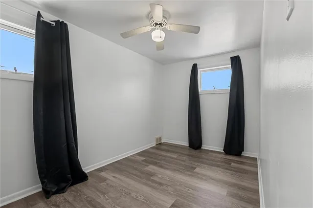 an empty room with wooden floor and closet