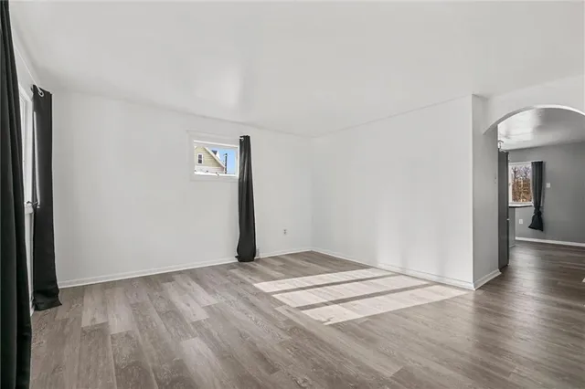 a view of an empty room and wooden floor
