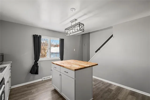 a utility room with a sink dryer and window
