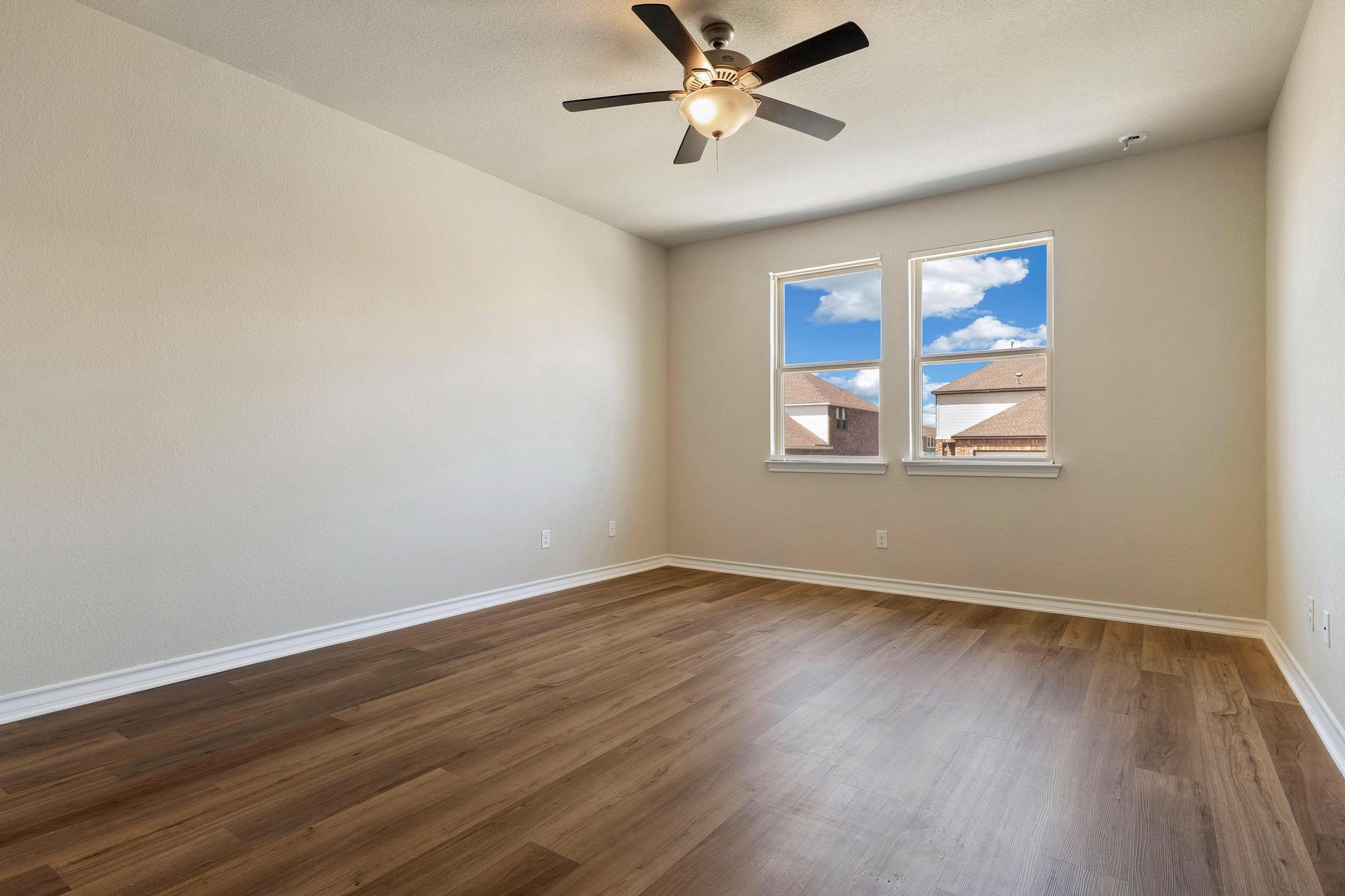 1341 Eagle Ray Street Leander, TX 78641 - Photo 15 of 37 An inviting room features resilient wood-look flooring and a modern ceiling fan for comfort.