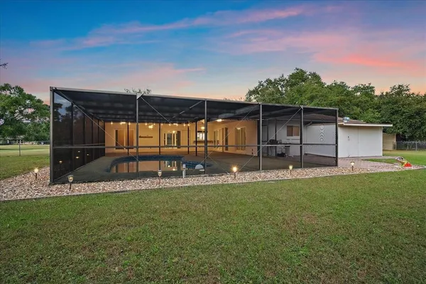 a view of a backyard with sitting area
