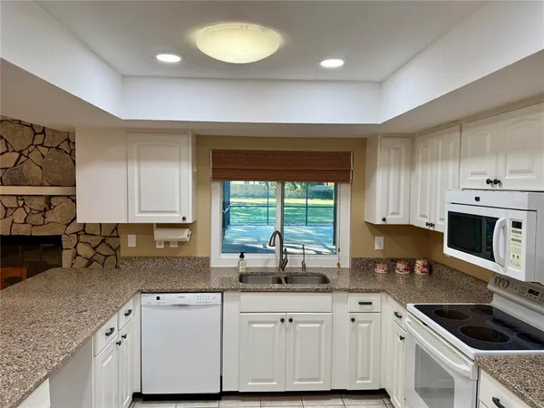 a kitchen that has a sink and a stove