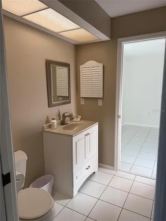 a bathroom with a sink a toilet and mirror