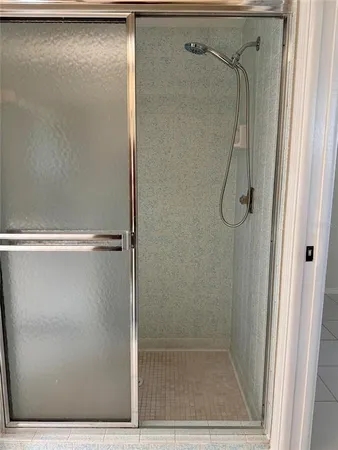 a bathroom with a glass shower door