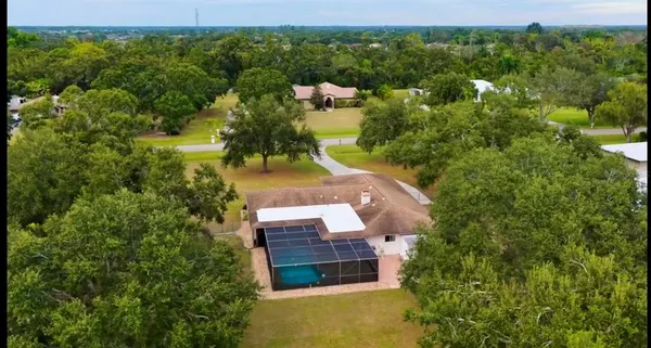 an aerial view of a house with a yard lake view