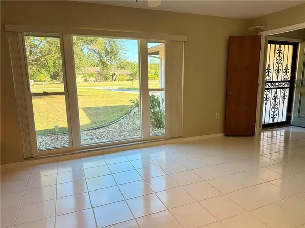 a view of empty room with floor to ceiling windows