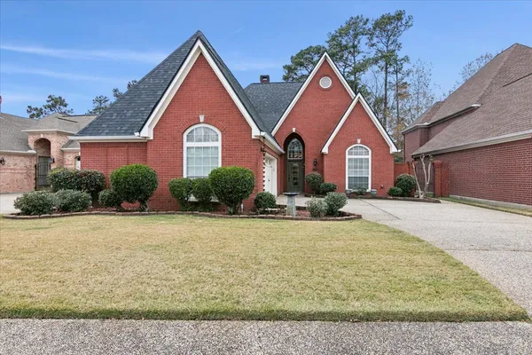 a front view of a house with yard and green space