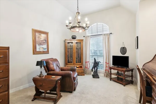 a living room with furniture a flat screen tv and a window