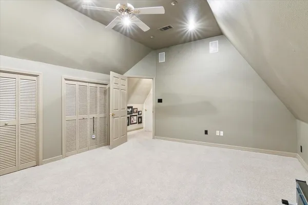 en empty room with closet and chandelier fan