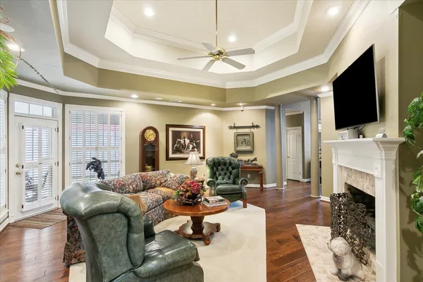 a living room with furniture a fireplace and a flat screen tv