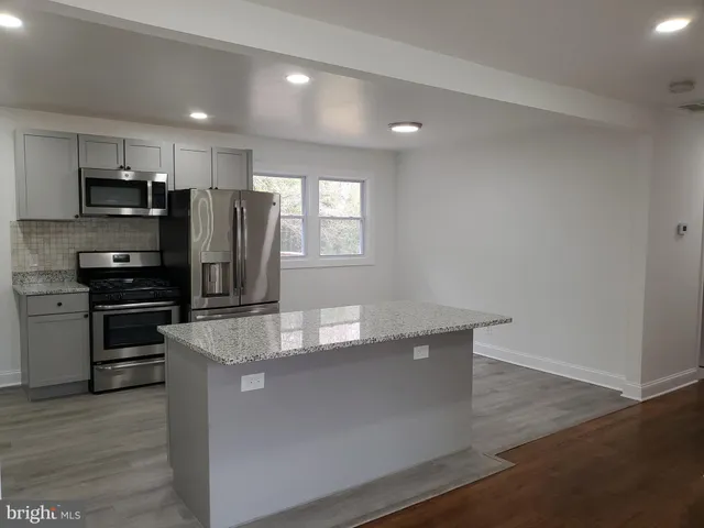 a view of hallway with wooden floor