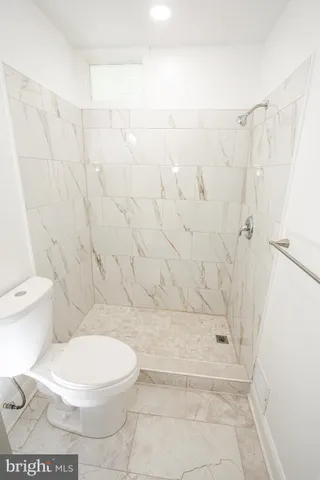 a bathroom with a sink a toilet and a shower