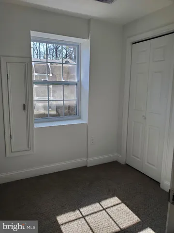 a view of hallway with wooden floor