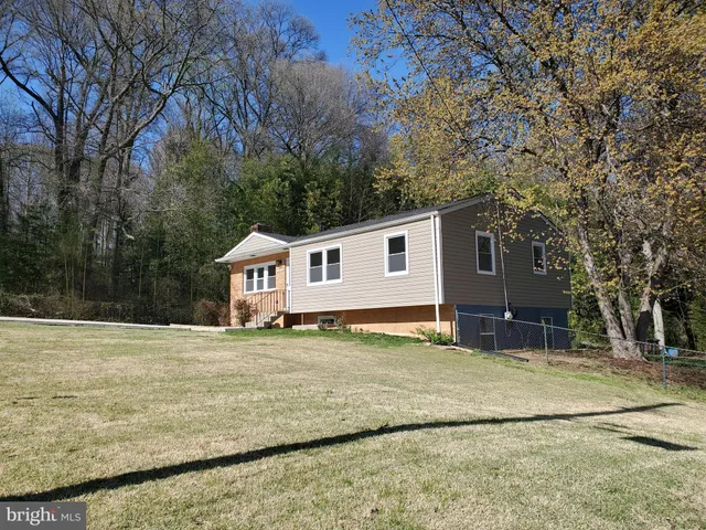 a house that has a tree in front of it