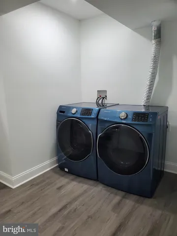 a kitchen with a sink a refrigerator a window and cabinets