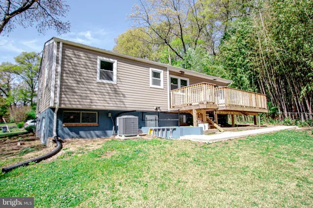 a view of a house with a patio and a yard