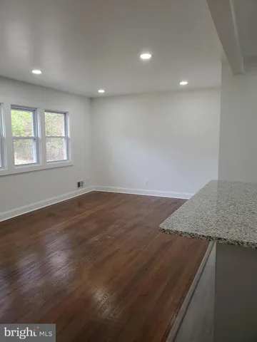 an empty room with wooden floor