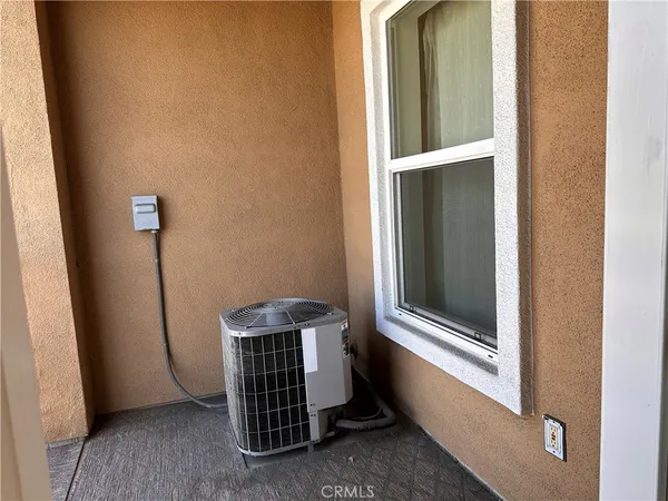 an empty room with wooden floor and a window