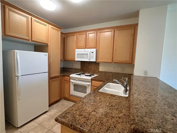 a kitchen that has a sink and a stove