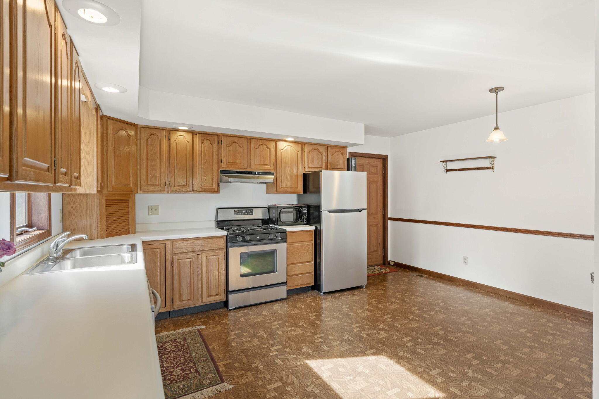 654 Harvest Court Crown Point, IN 46307 - Photo 13 of 43 a kitchen with granite countertop a refrigerator stove top oven and sink
