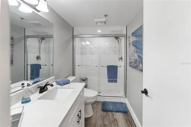 a spacious bedroom with a bed and a ceiling fan