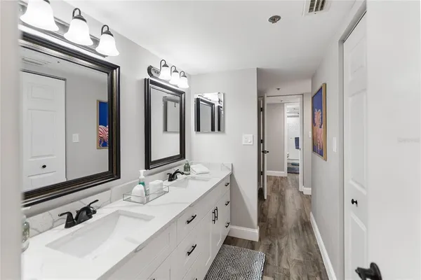 a bedroom with a bed and a mirror