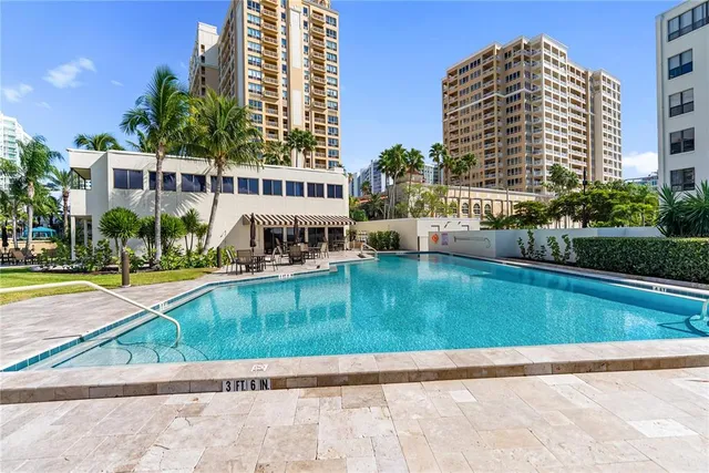 a view of a house with a backyard and a tree