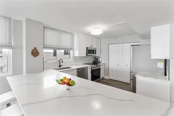 a kitchen with a refrigerator stove and microwave